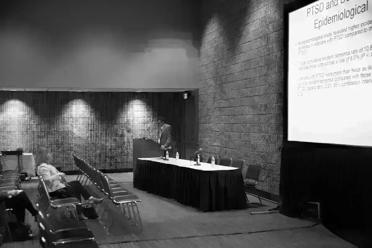 Presenter talks in a conference about depression.